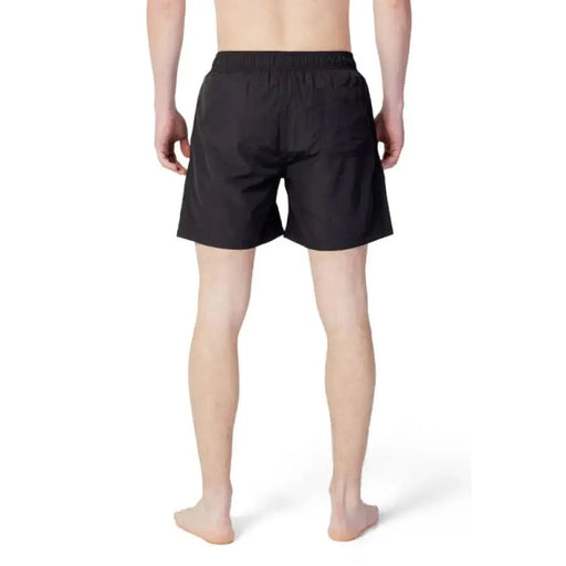 Armani Exchange Men Swimwear featuring black swim or athletic shorts worn waist down