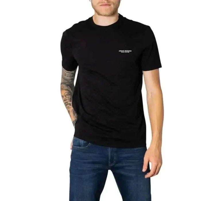 Model wearing Black ’Armani Exchange’ T-shirt, showcasing brand logo and tattooed arm