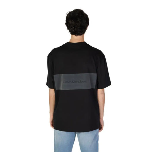 Black Calvin Klein Jeans T-shirt featuring a dark gray horizontal stripe on the back