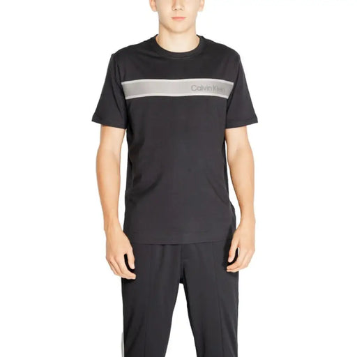 Black Calvin Klein Sport T-shirt with gray stripe and logo across the chest