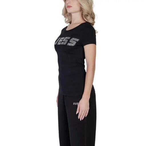 Black Guess Women’s T-shirt featuring bold GUESS text across the chest