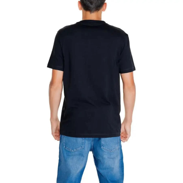 Person wearing a Black Calvin Klein Jeans Men T-Shirt seen from behind