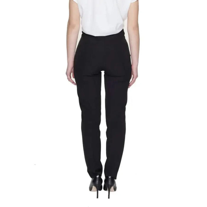 Black tailored trousers paired with a white top and black heels from Silence - Women Trousers