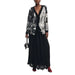 Elegant black and white patterned cardigan layered over a long black dress by Desigual