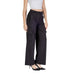 Black wide-leg cargo pants with side pockets paired with a white crop top by Ichi