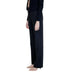 Black wide-leg Guess trousers paired with nude high heels for a stylish look