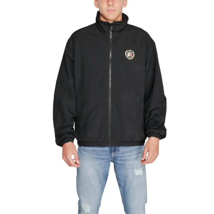 Black zip-up Tommy Hilfiger Men Jacket featuring a small circular logo on the chest