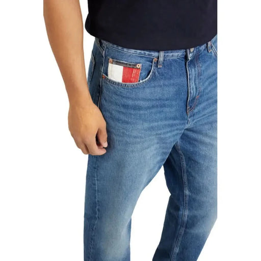 Blue denim Tommy Hilfiger Jeans featuring distinctive red, white, and blue pocket detail