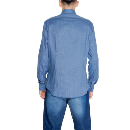 Back view of person wearing Calvin Klein blue long-sleeved button-up men shirt