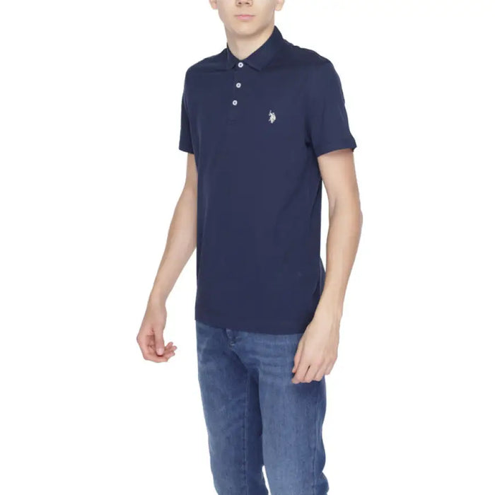 A boy in a navy polo shirt from U.S. Polo Assn. Men Polo Collection