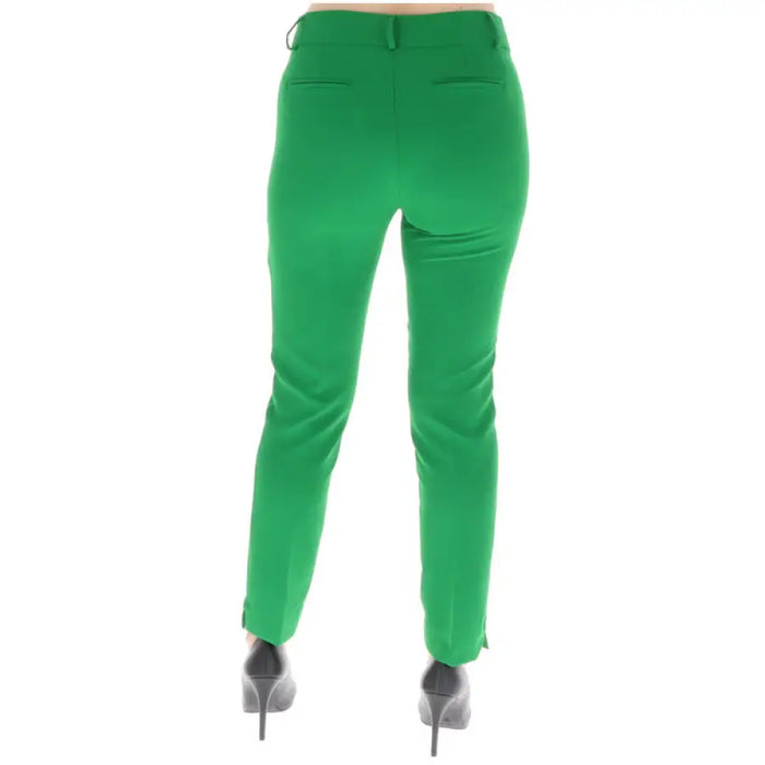 Bright green tailored pants paired with silver high heels from Sol Wears Women Trousers