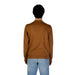 Brown long-sleeved sweater paired with light blue jeans from Gas Men’s collection