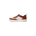 Casual sneaker featuring white and rust-colored leather panels with blue interior lining