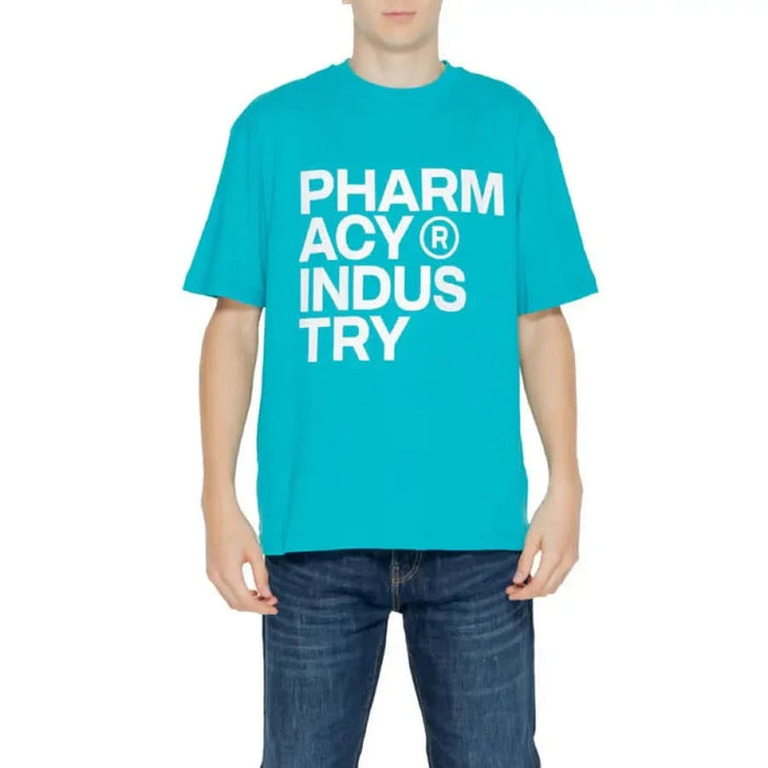 Young man in blue ’Pharmacy’ T-shirt embracing urban style clothing