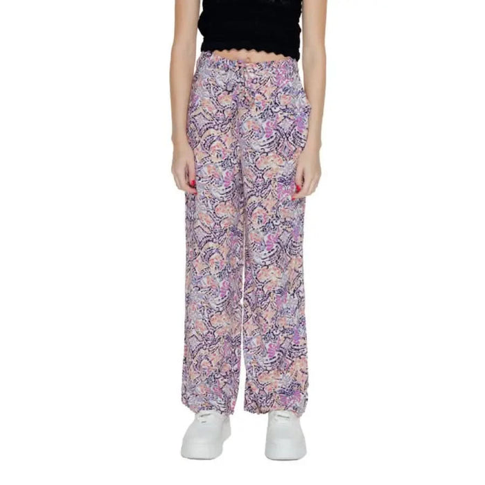 Colorful patterned wide-leg pants with black crop top & white sneakers by Only Women Trousers