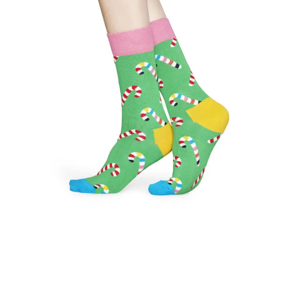 Colorful candy cane patterned socks from Happy Socks on a green background
