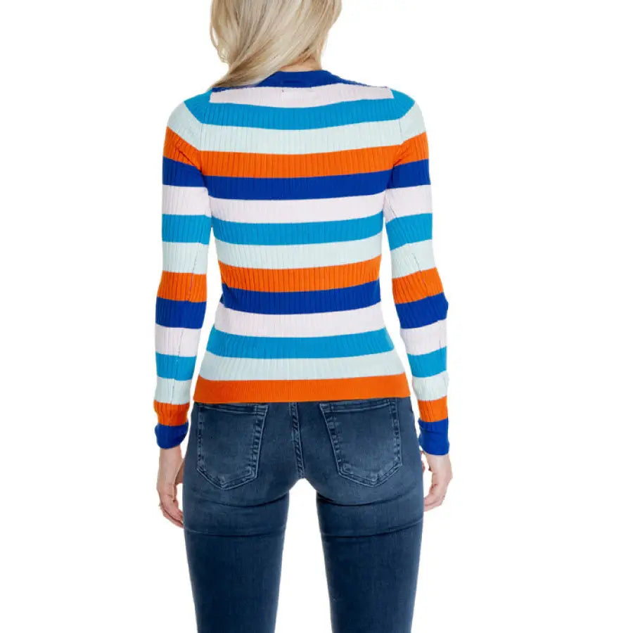 Colorful striped long-sleeve sweater paired with blue jeans from Only Women Knitwear