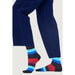 Colorful striped socks paired with navy blue pants from Happy Socks Men Underwear