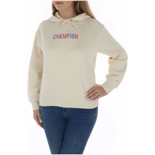 Champion Women Sweatshirt: Cream-colored hoodie with multicolored lettering and blue jeans