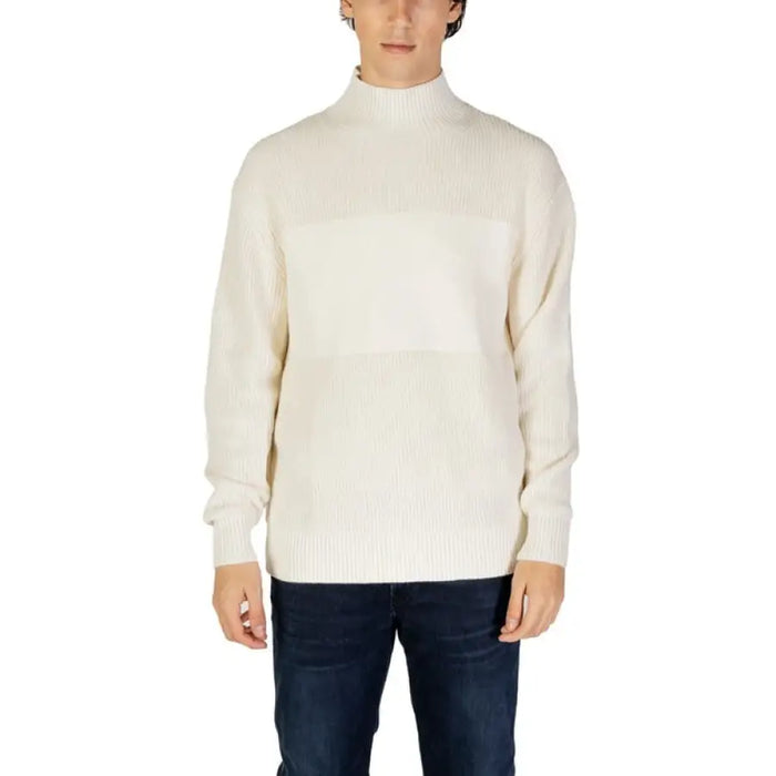 Cream-colored mock turtleneck sweater with ribbed knit texture by Calvin Klein Jeans