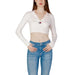 Cropped white ribbed sweater with Tommy Hilfiger logo over blue jeans - Women’s Knitwear