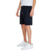 Dark blue denim shorts by Jack & Jones paired with white sneakers worn by a person