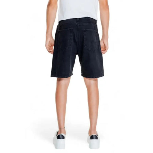 Jack & Jones Men Shorts: Dark blue denim shorts with back pockets worn by a person