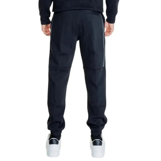 Calvin Klein Jeans Men Trousers: Dark blue sweatpants with white sneakers at the bottom