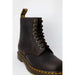 Dark brown leather Dr. Martens combat boot with yellow stitching and laces