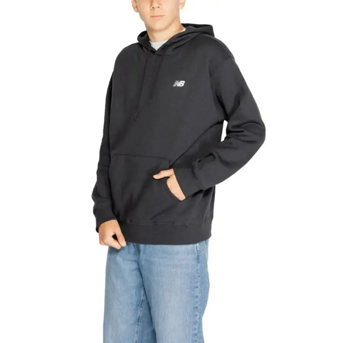 New Balance Men Sweatshirts in dark gray with blue jeans for a stylish, casual look