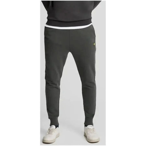 Dark gray Lyle & Scott sweatpants with yellow logo on upper left thigh