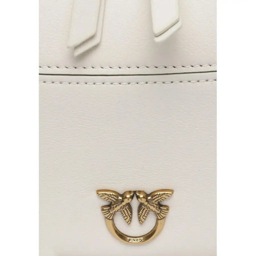 Gold-colored metal pin with two birds in a circular design on Pinko Women Bag