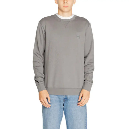 Gray crewneck sweatshirt modeled by a person from Boss Men Knitwear