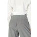 Gray pinstriped dress pants paired with a white blouse from Rinascimento Women Trousers