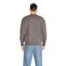 Gray sweater worn by a person seen from behind in Armani Exchange Men Knitwear