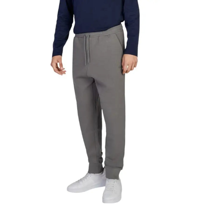 Gray Boss Men Trousers featuring elastic cuffs at the ankles for comfort and style