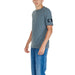 Grey Calvin Klein Jeans T-shirt with sleeve patch paired with blue jeans