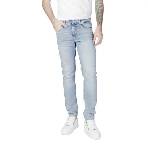 Light blue denim jeans worn by a person from Calvin Klein Jeans for men