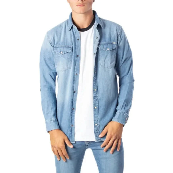 Light blue denim button-up shirt over white t-shirt by Jack & Jones Men