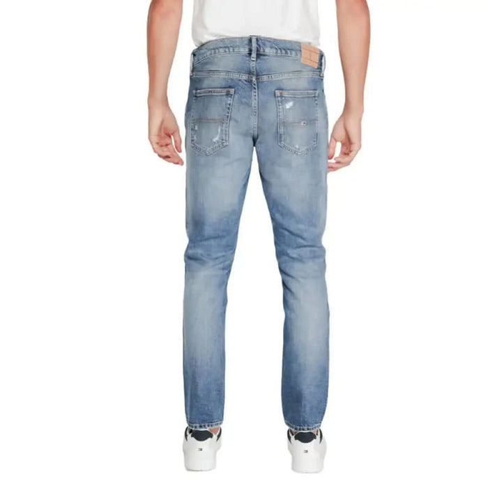 Light blue distressed jeans worn by a person from behind, Tommy Hilfiger Men Jeans