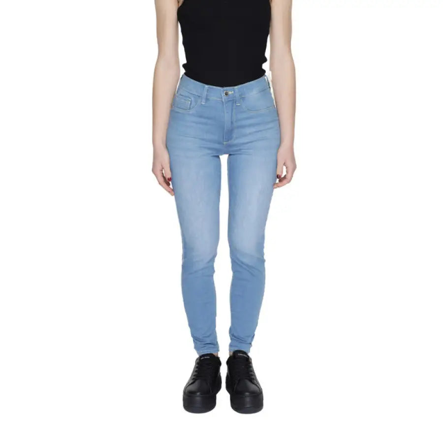 Light blue skinny jeans with a black top and black platform shoes from Gas Women Jeans