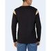 Man wearing Alviero Martini Prima Classe black T-shirt with gold detailing