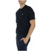 Lyle & Scott men t-shirt modeled by a man in shorts