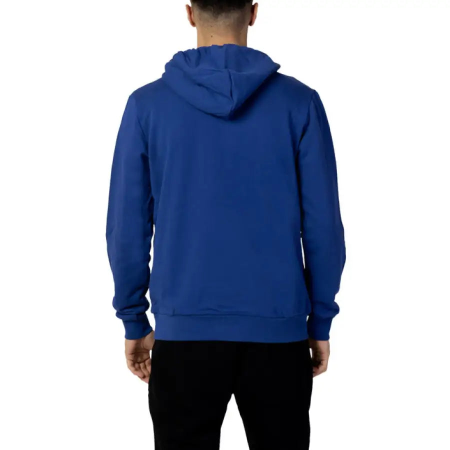 Man wearing a blue hoodie from Cnc Costume National Men Sweatshirts collection