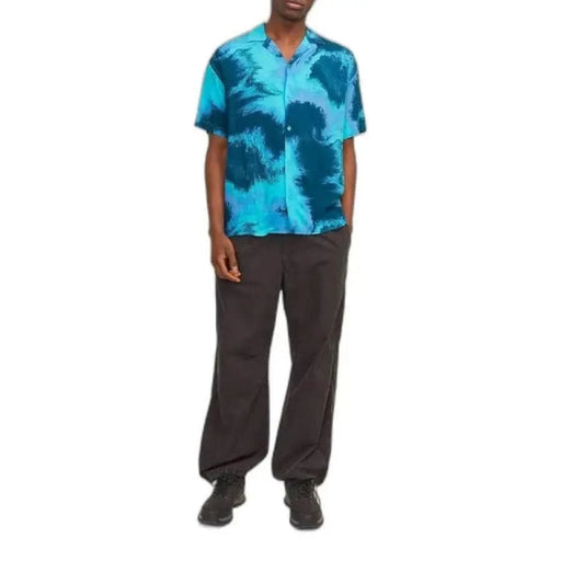 Man modeling Jack & Jones men shirt in blue with black pants