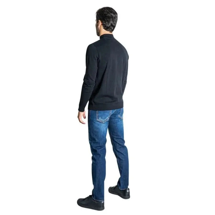 Man in dark sweater and blue jeans from behind in Jack & Jones Men Knitwear