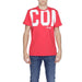 Man in Icon Icon Men T-Shirt wearing red with ’CO’ logo