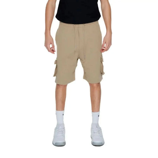 A man in shorts and a black shirt from the Pharmacy - Pharmacy Men Shorts collection