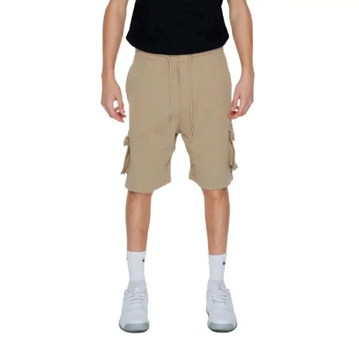 A man in shorts and a black shirt from the Pharmacy - Pharmacy Men Shorts collection