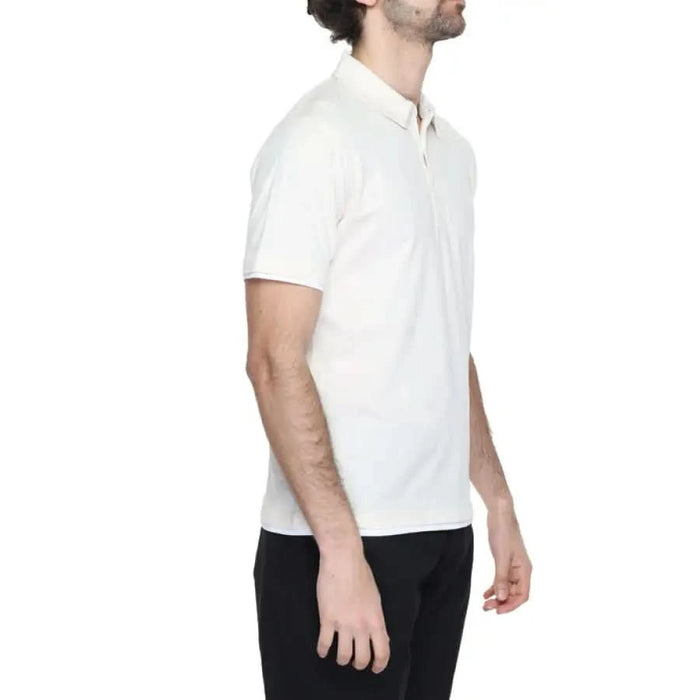 Man in white Hamaki-ho polo and black pants showcasing urban city style clothing